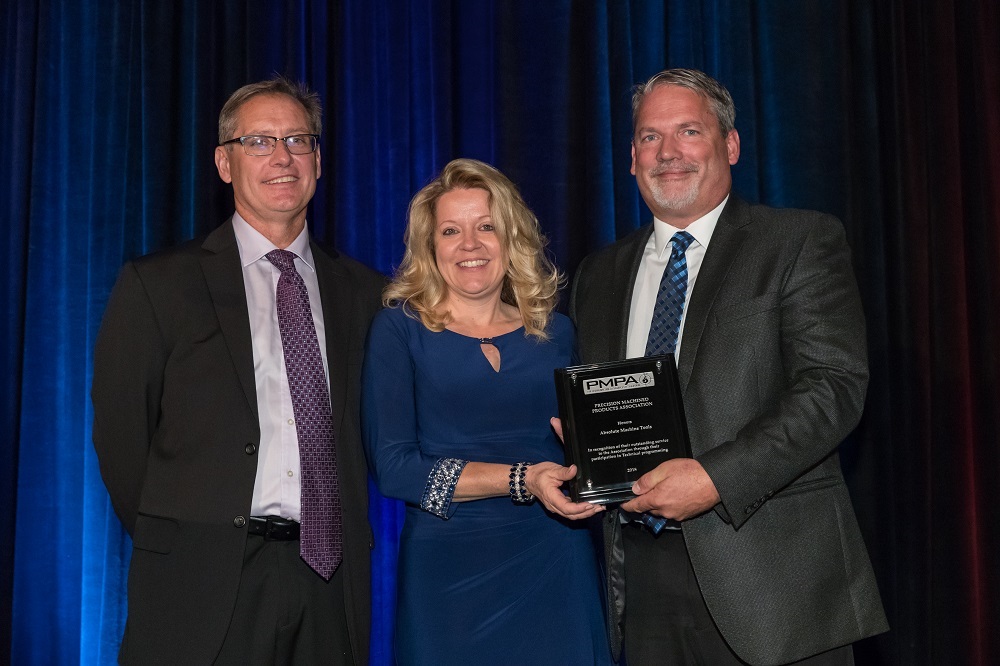 Absolute Machine Tools President Steve Ortner and Chief Marketing Officer Courtney Ortner accept the PMPA Technical Member Participation Award from then-president Mike Preston.